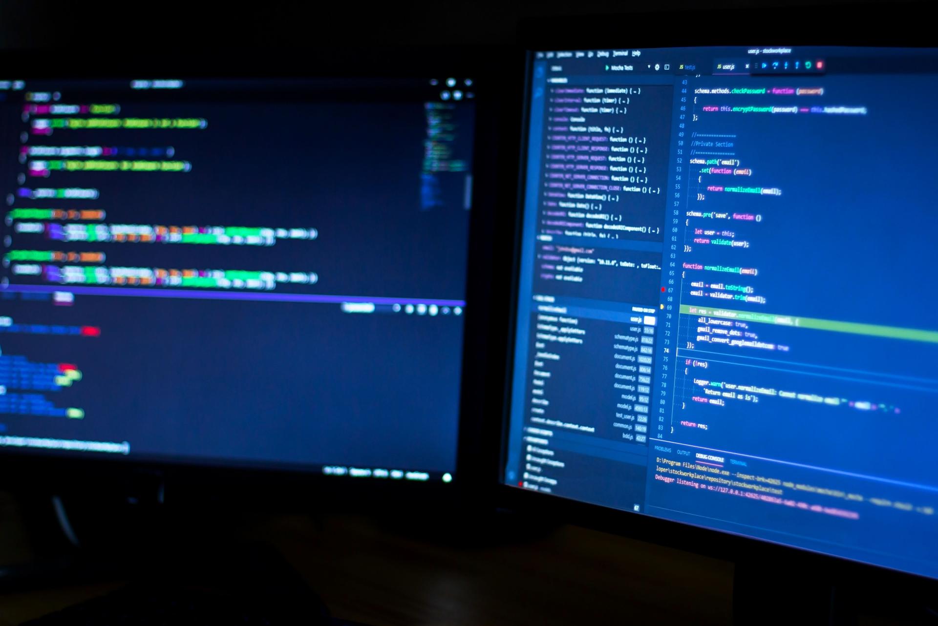 2 écrans PC avec du code - cybersécurité IA